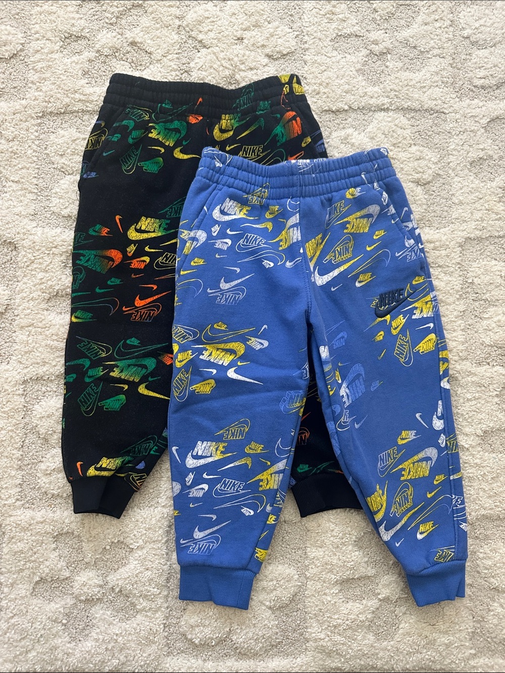 Nike Kids Graphic Joggers in Blue and Black with Multicolor Logos